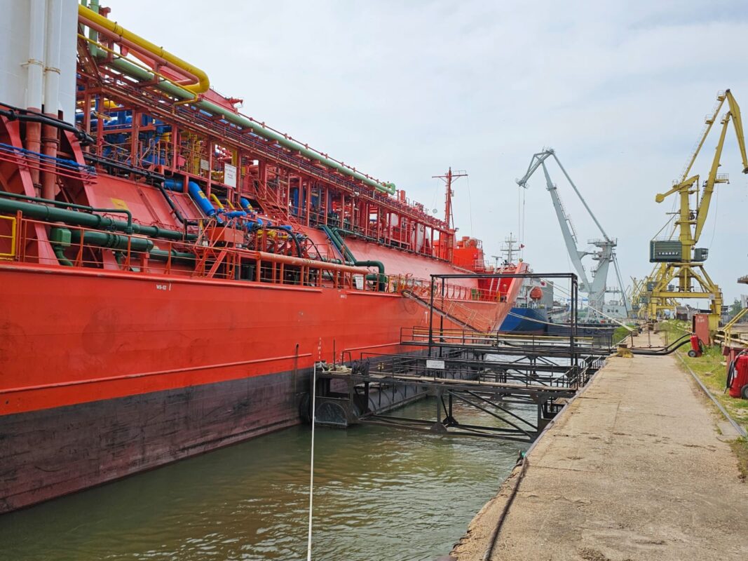 a large red ship in a port
